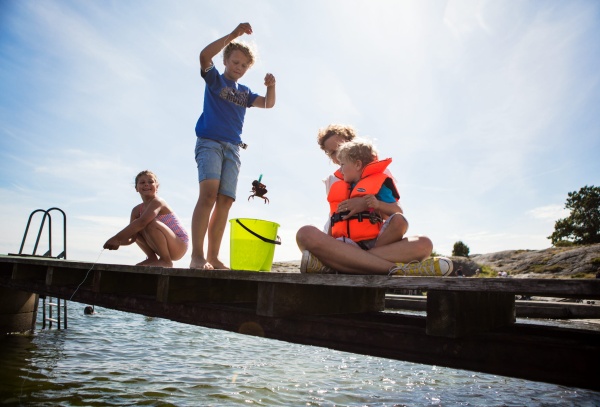 Children fishing crab from the jetty Photo cred